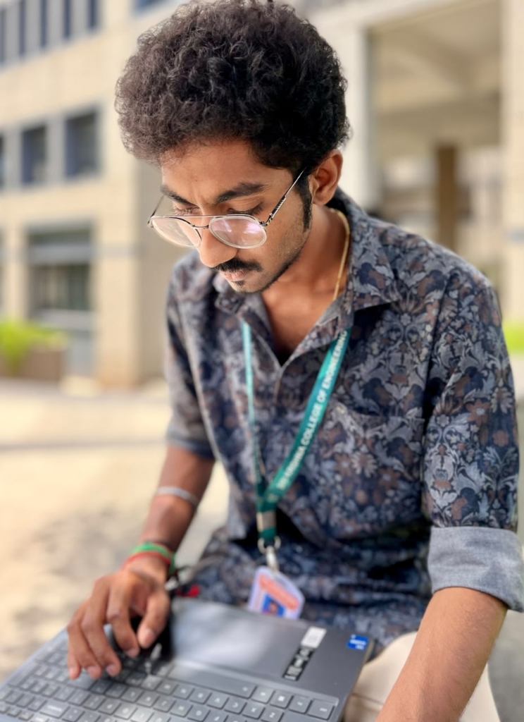 Rejiesh Ashwanth working on laptop at SKCET campus for ADYK Multi Venture